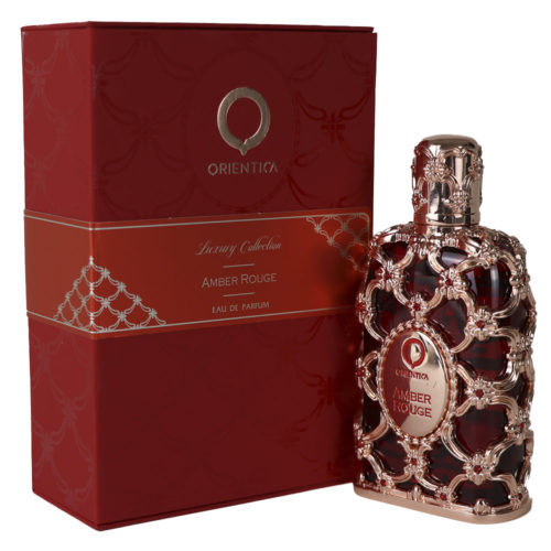 Frasco de cristal rojo de Orientica Amber Rouge Eau de Parfum, decorado con una capa floral dorada, expuesto junto a su lujosa caja roja a juego.