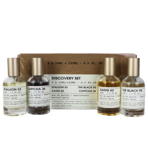 Un set de descubrimiento con cuatro frascos de perfume de 30 ml etiquetados como "Stallion 53," "Captcha 36," "Ilang 62," y "The Black 92," exhibidos frente a una caja de cartón sencilla.