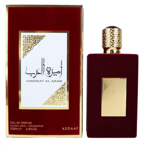 Un frasco de perfume rectangular de color rojo oscuro con una placa dorada y una tapa texturizada dorada, junto a un empaque rojo y dorado a juego etiquetado como "Ameerat Al Arab" de Asdaaf.