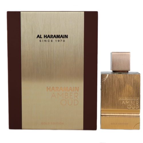 The "Amber Oud Gold Edition" perfume box displayed alongside the matching bottle. The bottle features a brushed gold finish and a square-shaped cap, mirroring the luxurious packaging.