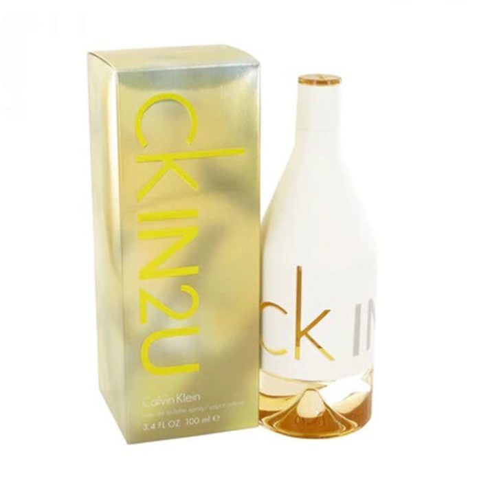 CK IN2U Eau de Toilette 100 ml para Mujer de Calvin Klein. Un frasco de perfume moderno en blanco y dorado con un diseño minimalista, con el logo "ck IN2U" en dorado. A su lado, una caja metálica dorada a juego con letras amarillas en negrita que muestran el nombre de la fragancia y la marca.