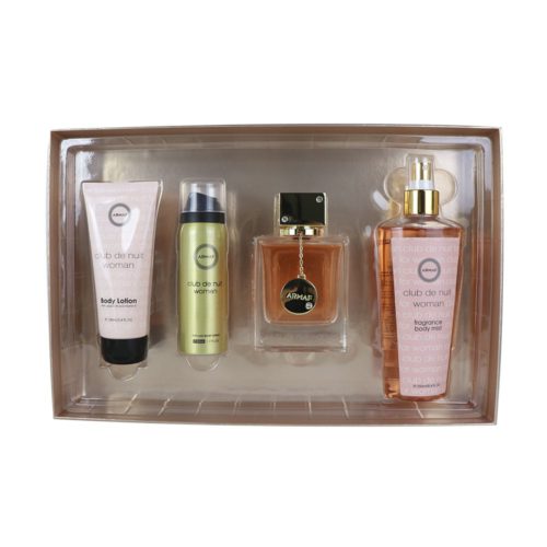 Caja abierta del set de regalo "Club de Nuit Woman" mostrando su contenido: una loción corporal rosada, un body spray dorado, una bruma perfumada dorada y un frasco de perfume con tapa negra y dorada. Los productos están organizados cuidadosamente en una bandeja de plástico dorada.