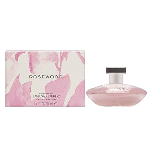 Rosewood Eau de Parfum 100 ml para Mujer de Banana Republic. Un frasco de perfume en tono rosa suave, de diseño elegante con tapa plateada, acompañado de una caja con un patrón floral abstracto en tonos rosados y blancos.