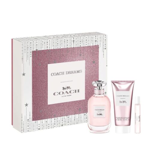 Set de regalo Coach Dreams con una caja rosa brillante, un frasco de perfume, un tubo de loción corporal y un spray de fragancia en tamaño de viaje.
