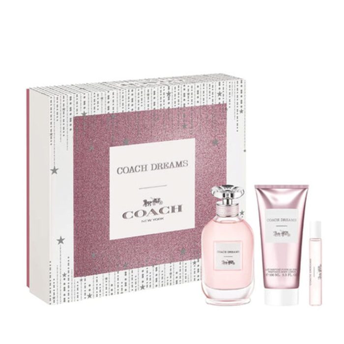 Set de regalo Coach Dreams con una caja rosa brillante, un frasco de perfume, un tubo de loción corporal y un spray de fragancia en tamaño de viaje.