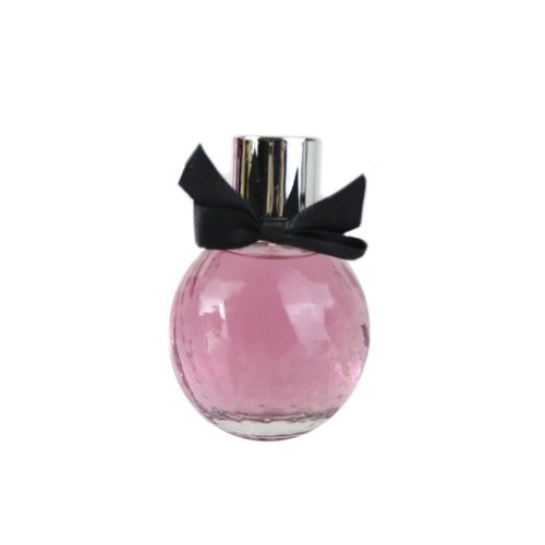 Frasco del perfume La Madame Pour Femme de Dubai Essences, redondo con líquido rosado y moño negro en el cuello del tapón.