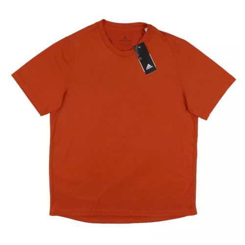 Camiseta naranja Adidas de manga corta modelo Creator Tee con cuello redondo y etiqueta visible.
