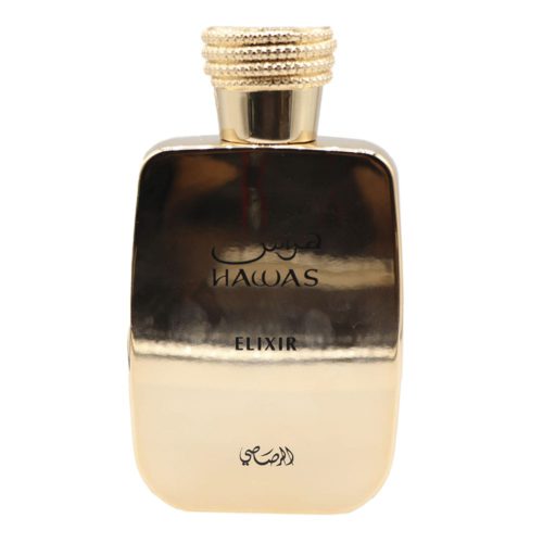 Primer plano del frasco del perfume Hawas Elixir en dorado brillante con caligrafía árabe y tapa acanalada.